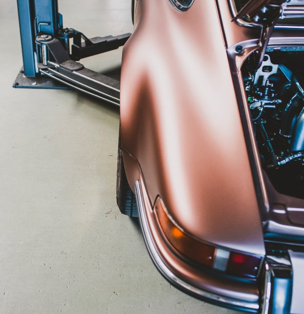 Close-up of salmon-colored car corner with ceramic window tint inside Diamond Window Tinting Chicago shop