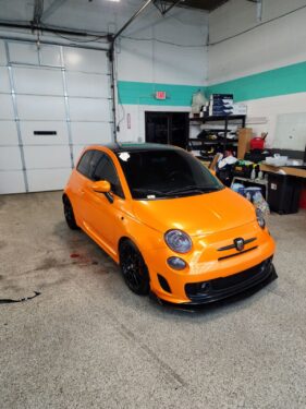 Fiat 500 Abarth in bright orange with full window tint, photographed at Ghost Industries after tinting by Diamond Window Tinting Chicago