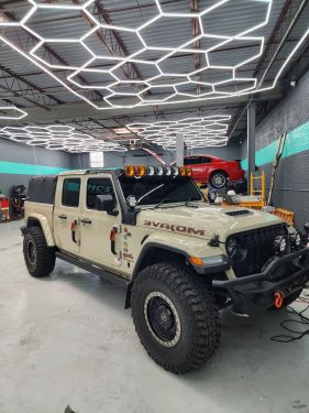 Jeep Gladiator Mojave with full off-road setup and window tint, photographed inside Ghost Industries after tinting by Diamond Window Tinting Chicago