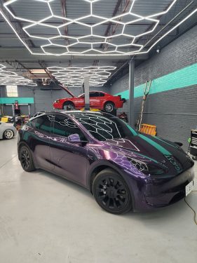 Tesla Model Y with purple color-shift wrap and ceramic window tint inside Diamond Window Tinting Chicago workshop
